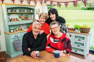 The Bake Off judges at a kitchen table