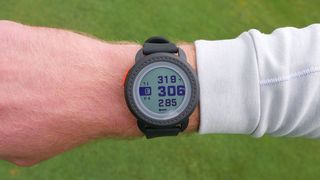 Bushnell iON Edge GPS Watch, man wearing Bushnell iON Edge watch, yardages displayed on golf watch