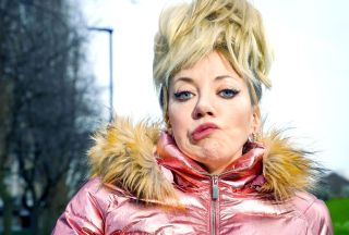 Diane Morgan as Mandy, with a high blonde hairdo, a pinched expression and a pink quilted jacket