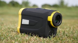 Inesis Golf 900 Laser Rangefinder lying on grass