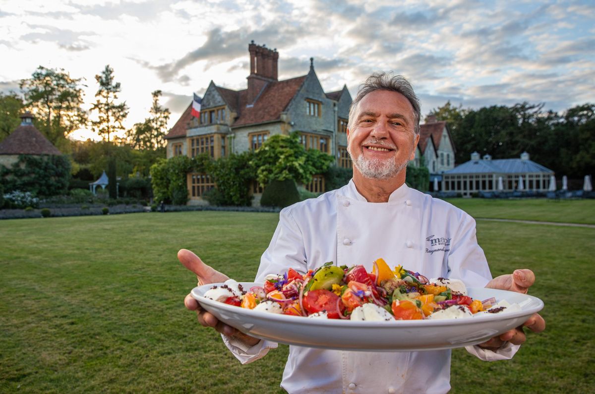 Raymond Blanc presents a delicious dish out vegetables outside Le Manoir Aux Quat&#039; Saisons