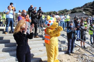 Pudsey Bear and a crowd of volunteers at this year's DIY SOS Children In Need special