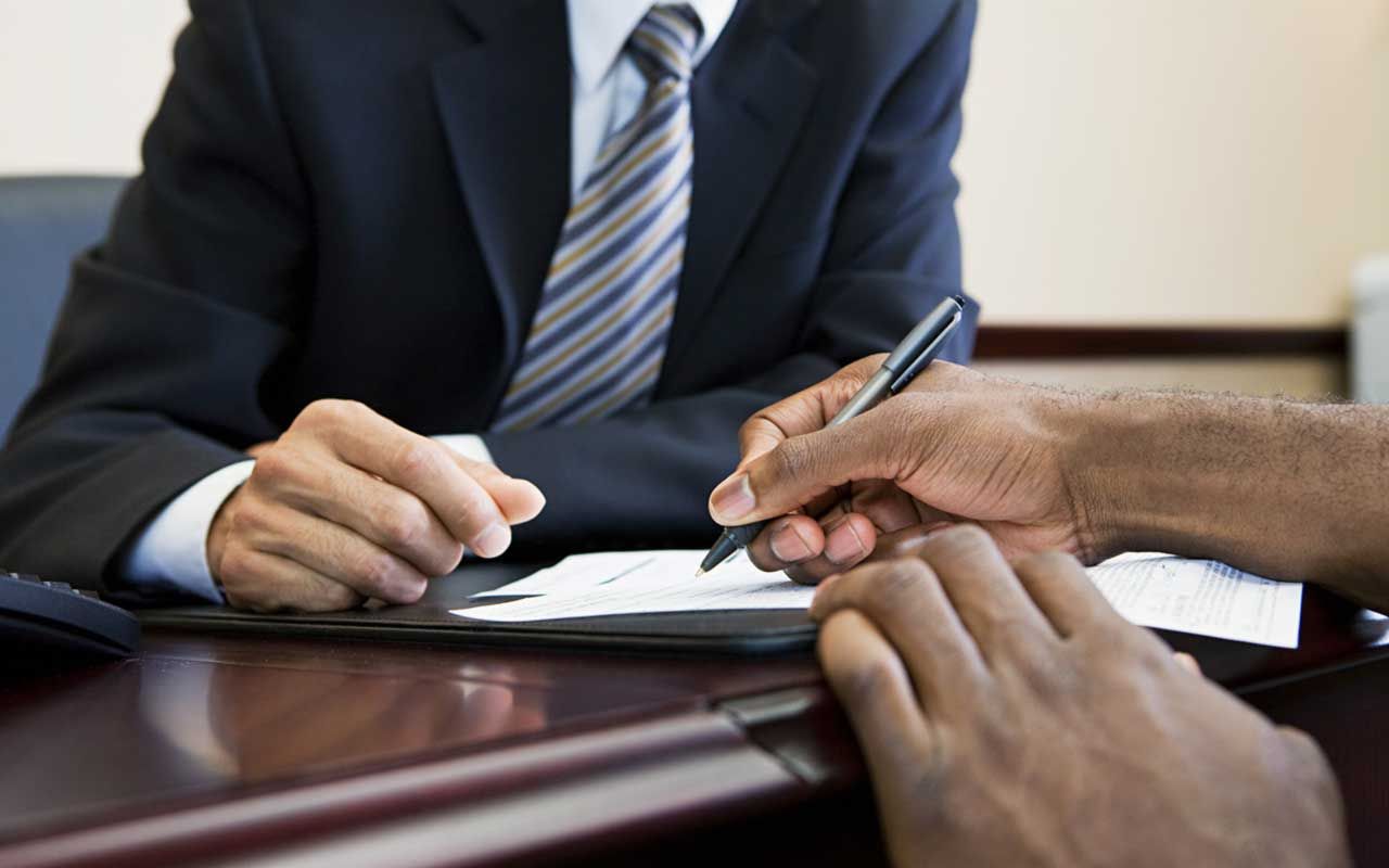 photo illustration of signing a loan