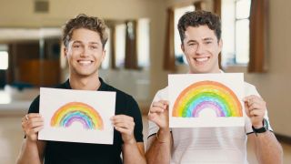AJ and Curtis Pritchard hold up pictures of rainbows for the NHS