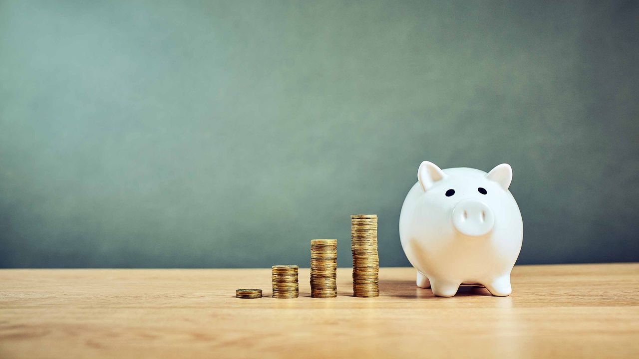 coins stacked by piggy bank