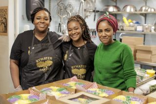 Nadiya poses with the women of the Bywater Bakery in New Orleans and their king cakes for Mardi Gras