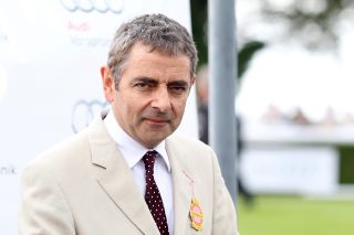 Rowan Atkinson in a cream suit at the races