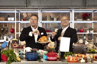 John Torode and Gregg Wallace behind a table full of food
