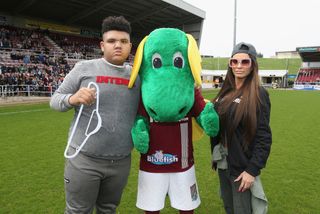 Katy Price and her son Harvey pose with Northampton Town mascot Clarence the Dragon prior to a Celebrity Charity Match at Sixfields on April 15, 2018 in Northampton