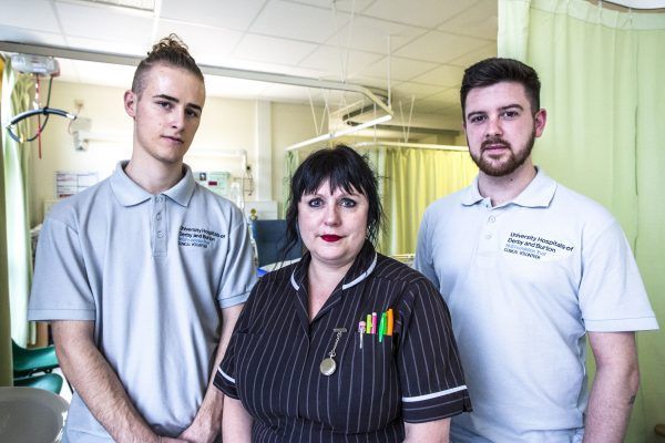 Volunteer Finlay Roberts, Senior Nurse Karen Hill and volunteer Michael Lowe in Elderly Ward at The Royal Derby Hospital