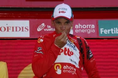 The taste of victory. Philippe Gilbert (Omega Pharma-Lotto) samples the red jersey.