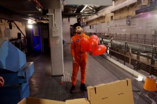 Mawaan Rizwaan holding balloons in the abandoned printworks