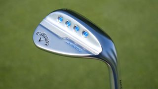 Callaway Jaws MD5 Wedge held up on the course showing its iconic weighting system