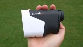 Garmin Approach Z82 Rangefinder in hand, man using Garmin laser