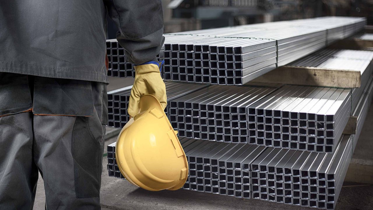 construction worker standing in front of steel beams