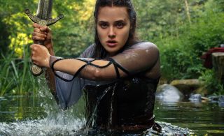 Katherine Langford emerges from a lake brandishing a sword in Netflix's Cursed